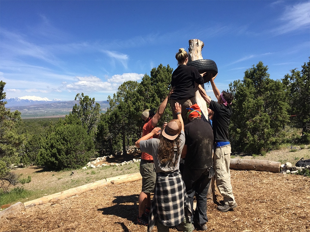 Students participate in a challenge course activity while at Aspiro Wilderness Adventure Therapy program
